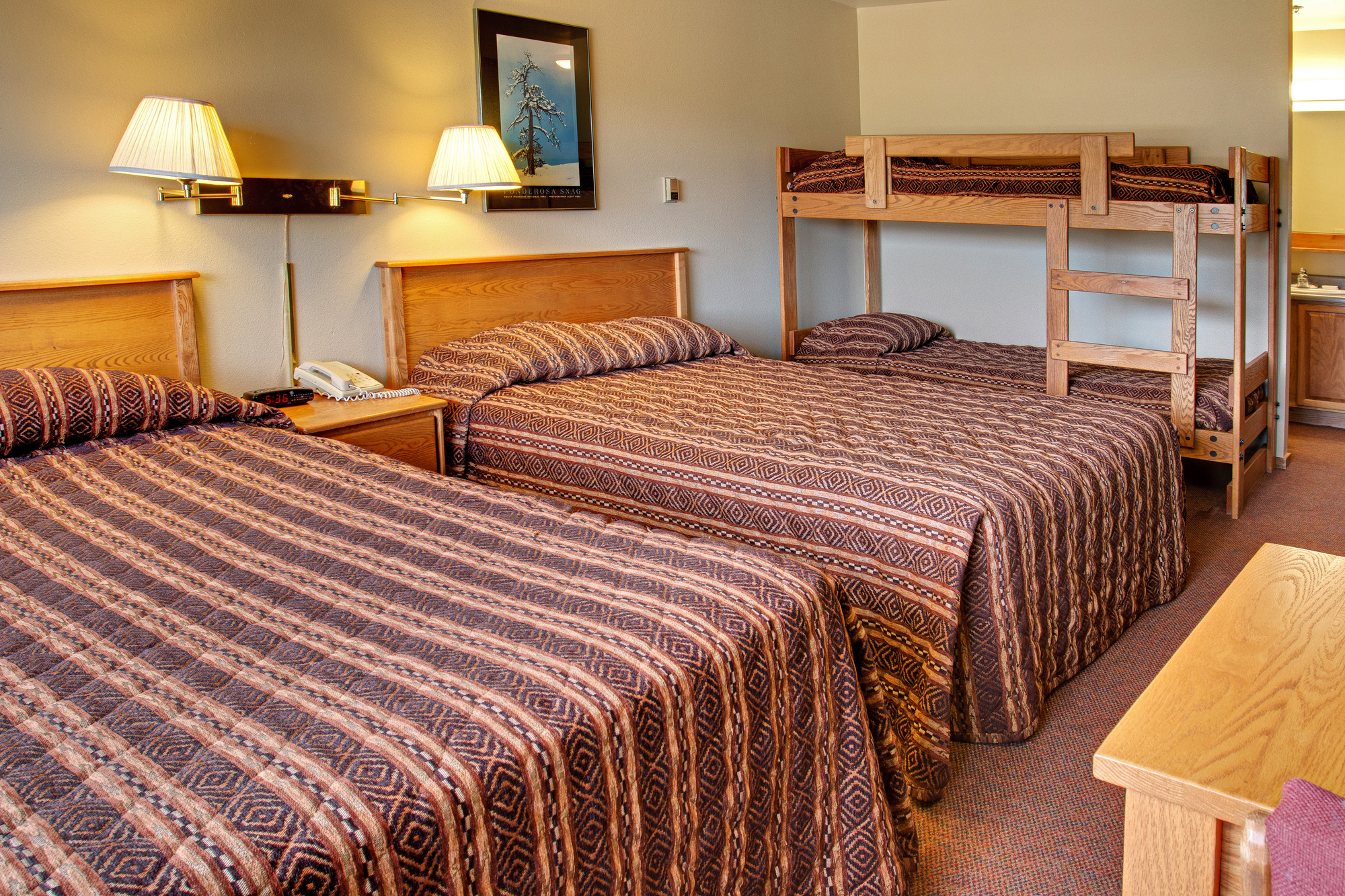 two queen beds and bunk beds in cabin