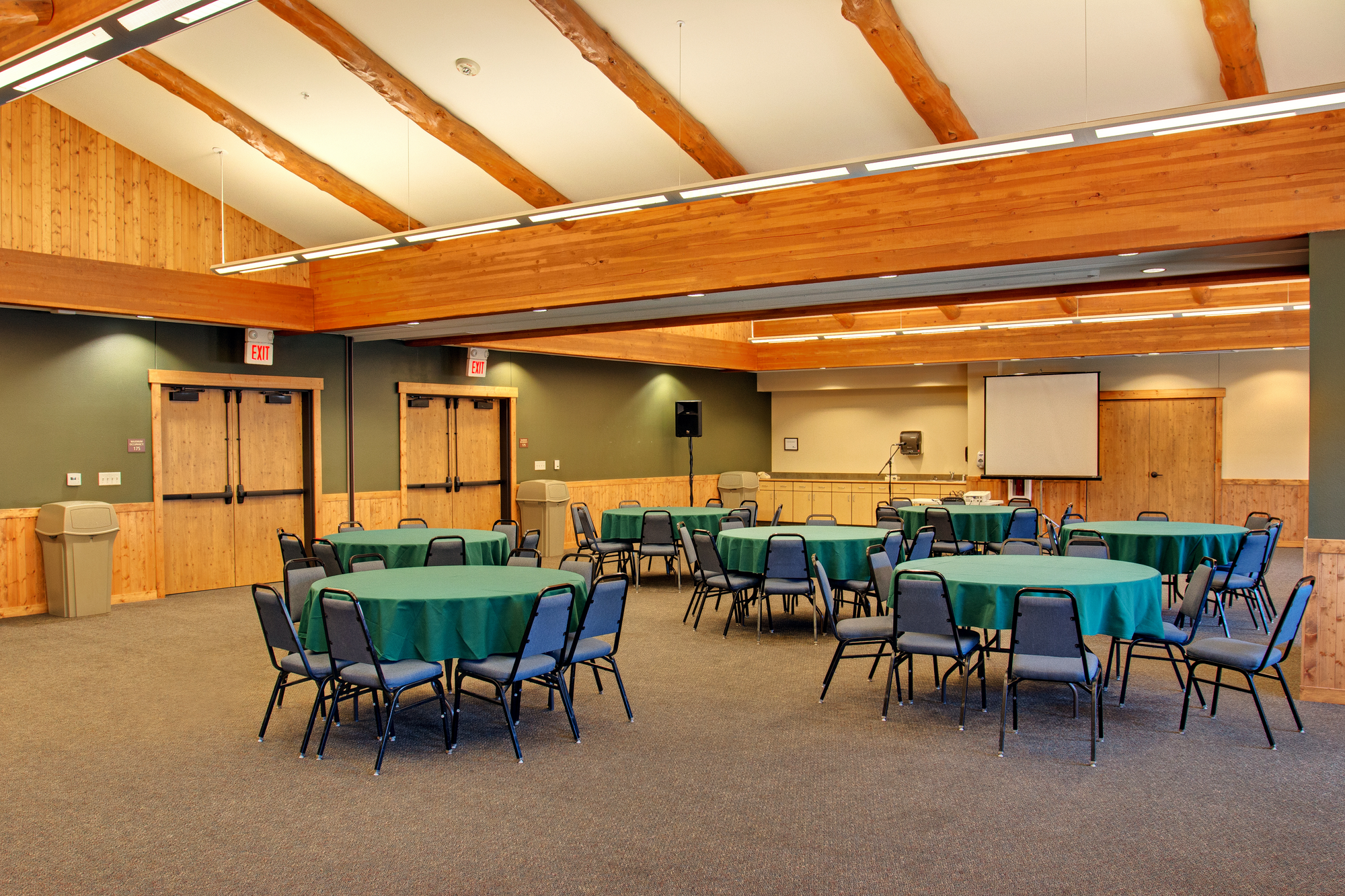 room with 5 round tables and chairs around them