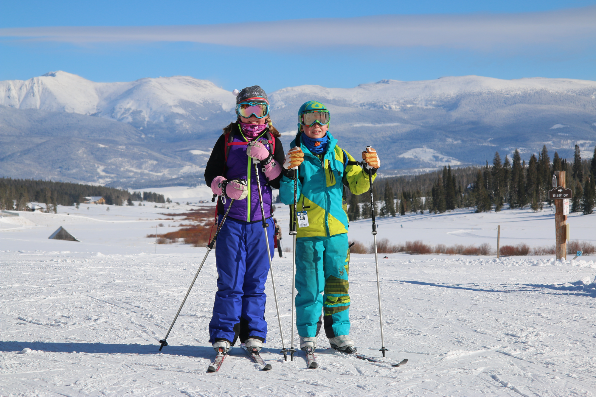 two people posing for a photo in ski gear
