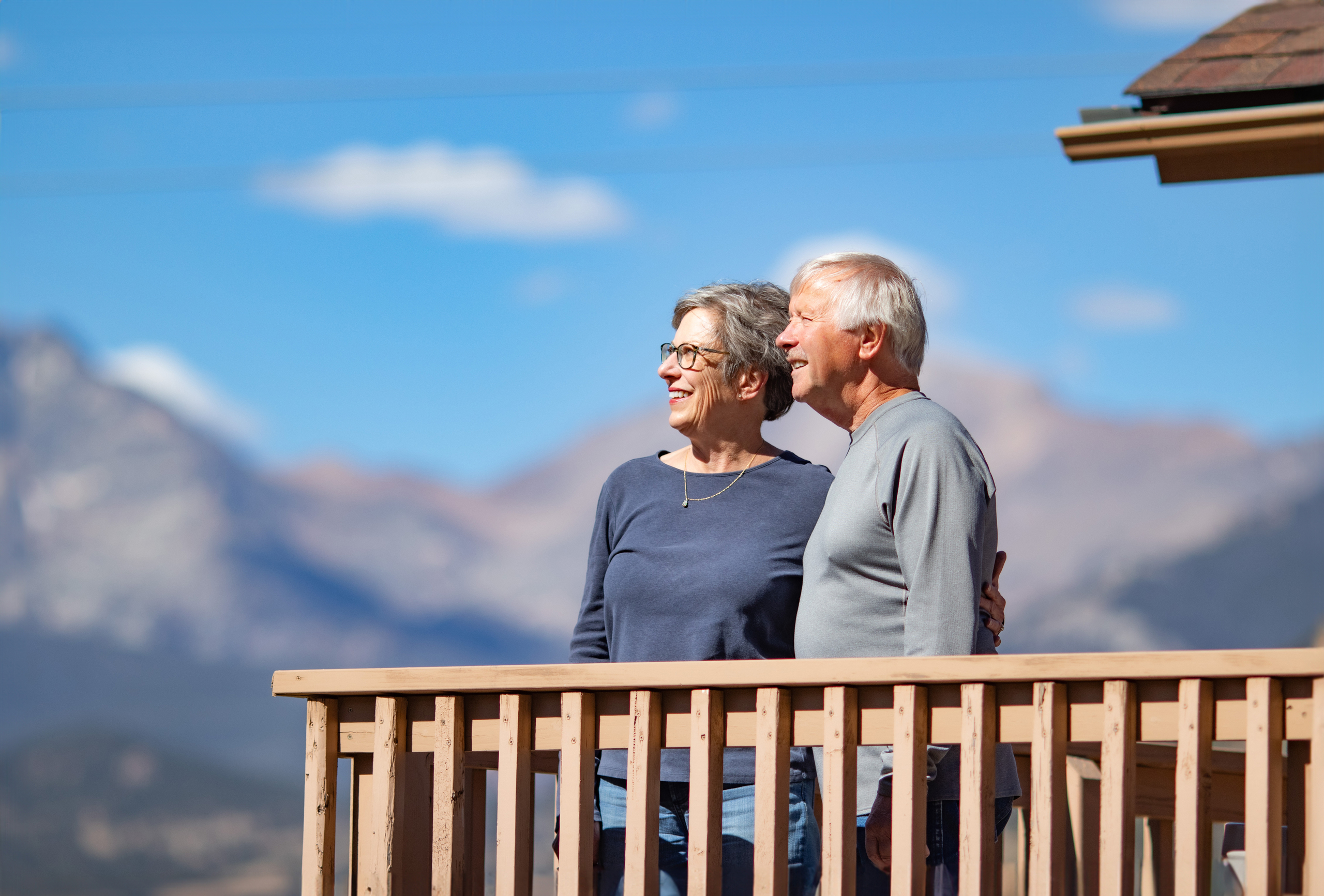 An elderly man and an elderly woman on a veranda