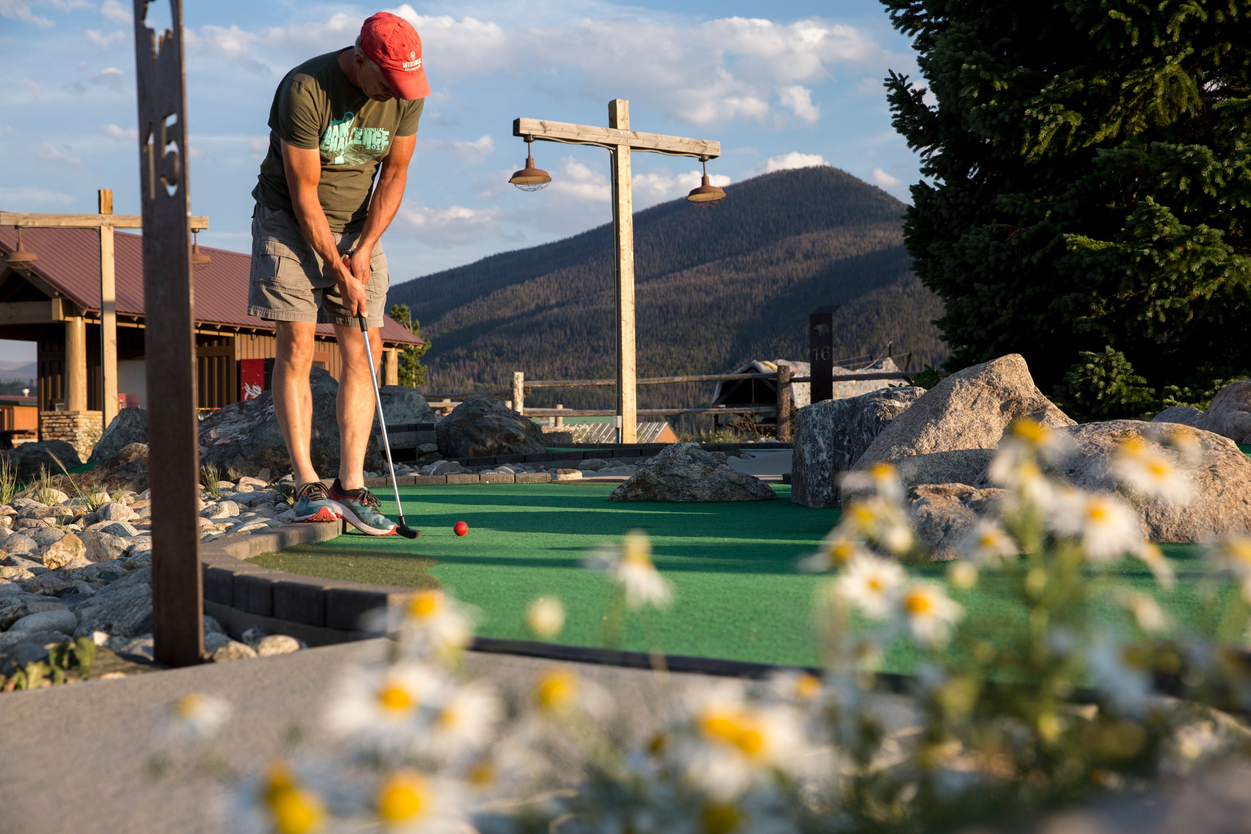 a man playing miniature golf