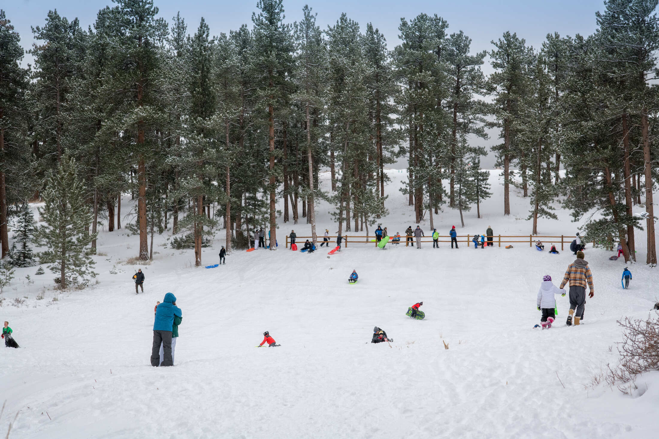 sledding hill with lots of people out in the snow