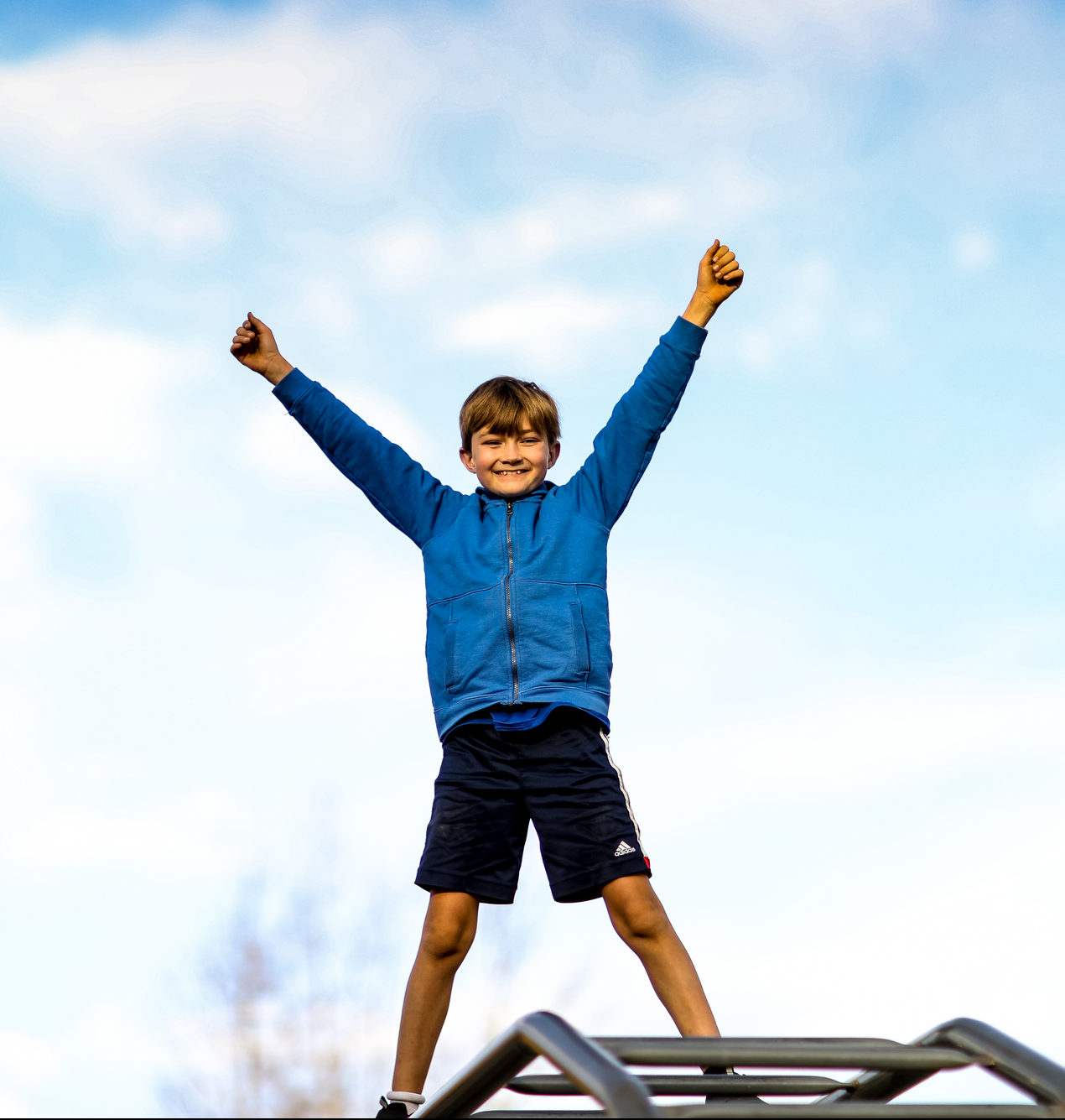 boy with arms in the air like he is celebratingg