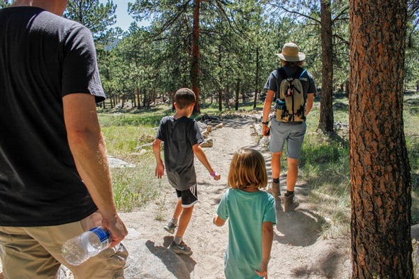 two adults and two kids hiking