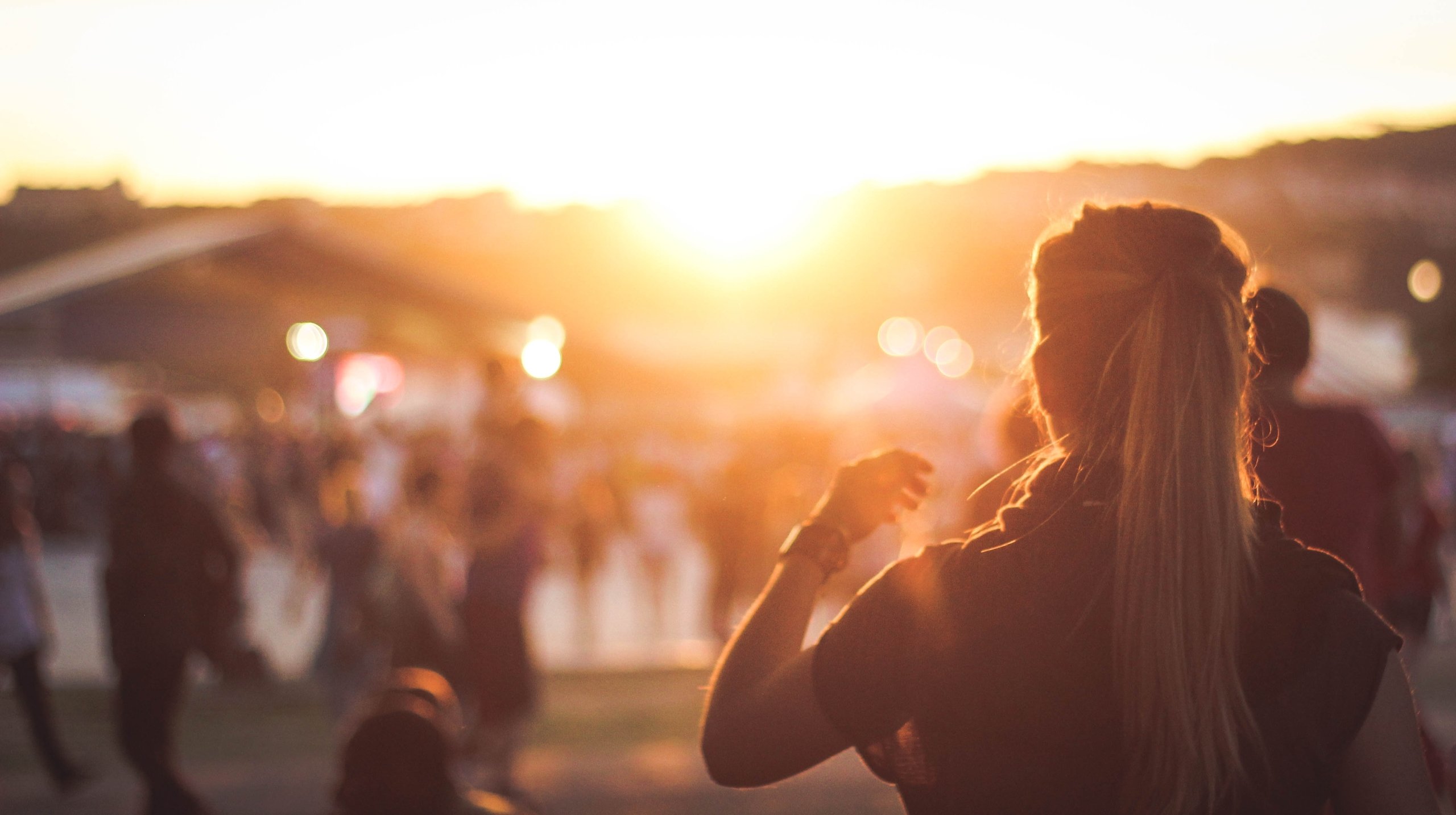 people at a festival in the sunset